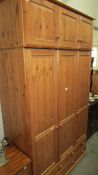 A solid pine 6 door, 4 drawer wardrobe.