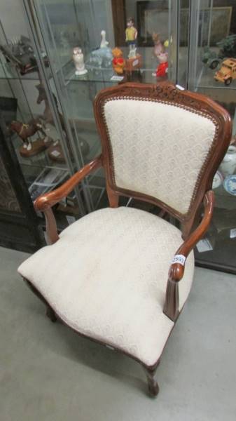 A mahogany framed elbow chair.