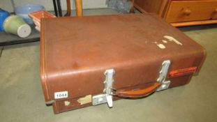 A vintage Revelation fibre glass suitcase and one other.