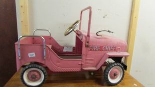 A metal Jeep Fire Chief pedal car.