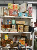 Three shelves of advertising tins.