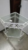 A vintage wrought iron porch/conservatory corner plant stand/table with frosted glass panels,