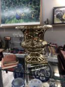 A large ceramic metallic gold coloured planter / urn