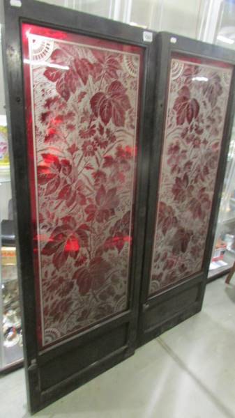 A pair of good quality large cabinet doors overlaid with ruby glass, cut and engraved to reverse.