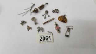 Ten vintage pendants and charms, one fashioned as a poodle dog, a vintage car,