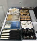 A selection of cutlery sets including teaspoons & knives