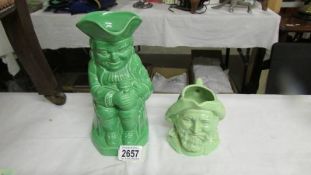 An early 20th century musical green Toby jug and a green fisherman jug.