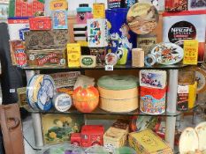 Three shelves of advertising tins.