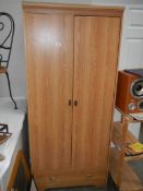 A two door wardrobe with single drawer.