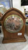 A mahogany inlaid 8 day mantel clock.