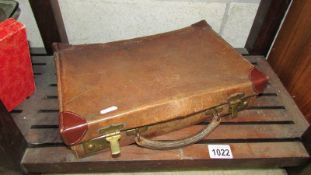 A small vintage suitcase with fitted letter compartments.