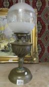 A Hinks brass oil lamp with original burner and later etched glass shade.