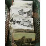 A large box of assorted vintage postcards.