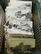 A large box of assorted vintage postcards.