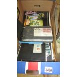 A box of USA stamps including mint year sets (7) sheets plus first day covers.