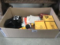 A quantity of photographic equipment including Praktica camera flash bulbs & expired film etc.