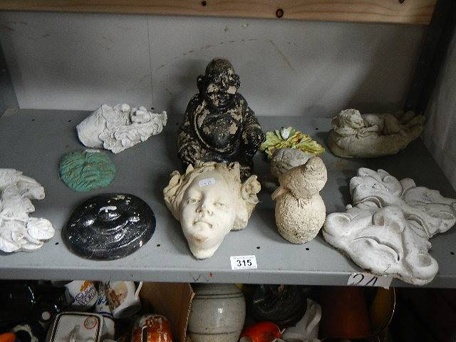 A shelf of garden figures.