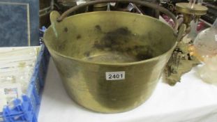 A large heavy brass jam pan.