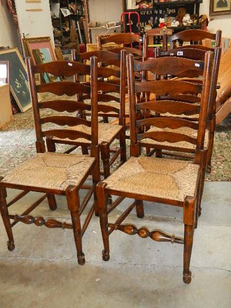A set of 6 oak ladder back chairs.