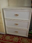 A white three drawer bedroom chest.