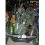 A box of glass advertising bottles. in need of a good clean.