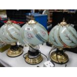 Three brass table lamps.