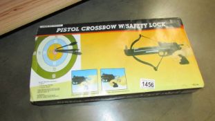 A boxed pistol crossbow with safety lock.