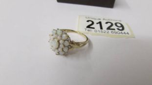 A 9ct gold opal cluster ring, size R, 2.8 grams total weight.