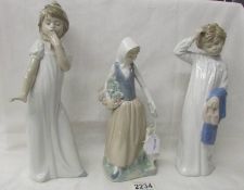 Three NAO figurines - 2 girls in night wear and girl with duck.