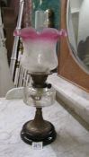 A Victorian oil lamp with later shade.