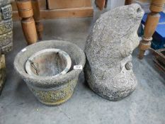 An old fish fountain and 2 pots.