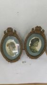 A pair of Victorian oval photo framed containing silk portraits.