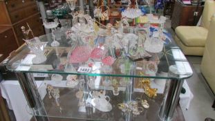 A good selection of filigree glass ornaments including bird bath, Cinderella coach etc, 2 shelves.