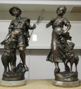 A pair of large spelter figures of shepherd and shepherdess on marble bases.