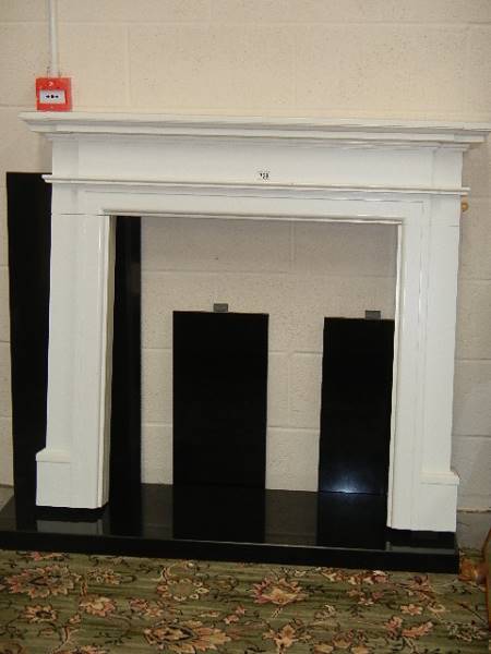 A good white fire surround with black marble base.