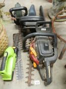 Four old hedge cutters.