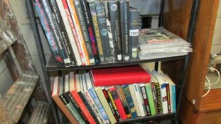 Two shelves of books relating to space travel and astronomy.