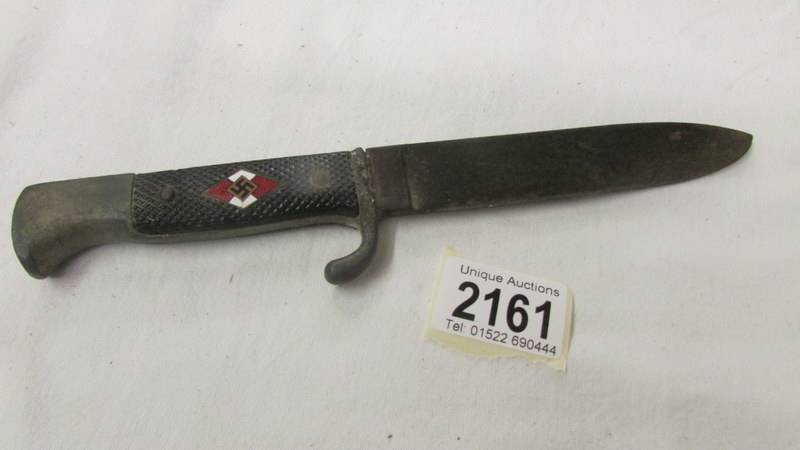 A WW2 German dagger with enamel insignia and stamped RZ M 7/27 1941 on blade.