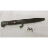 A WW2 German dagger with enamel insignia and stamped RZ M 7/27 1941 on blade.