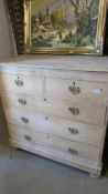 An old pine 2 over 3 chest of drawers with drop handles.