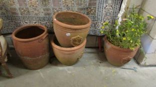 Four large terracotta garden pots.