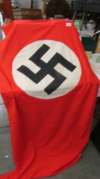 A red Nazi banner with central swastika.