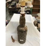 A large vintage bottle decorated with copper penny's & half pennies etc.