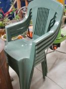 A set of 4 plastic garden chairs.