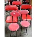 5 kitchen chairs with red seats.