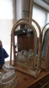 An arched bamboo framed dressing table mirror with matching tall arched top mirror.