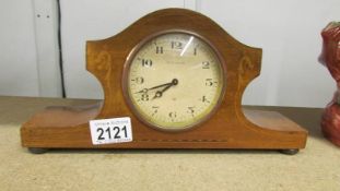 An 8 day mahogany inlaid mantel clock (not working).