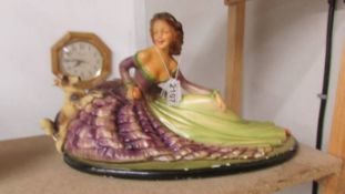 A large painted plaster figurine of a lady in crinoline dress with dog, some paint loss, stamped Rd.