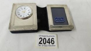 A hall marked sterling silver 1999 photo frame / clock.