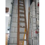 A 12 double rung wood ladder in good condition.